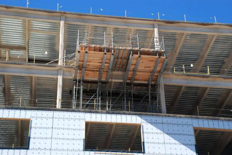 Cantilevered scaffold platform projecting beneath a building soffit, built by Ox Scaffold
