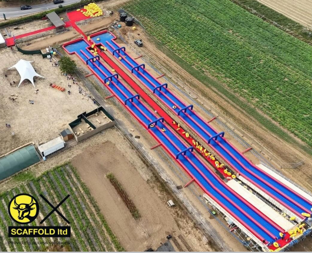 Aerial drone view of the four-lane Slip n Slide at Millets Farm, Oxfordshire, built on an Ox Scaffold structure